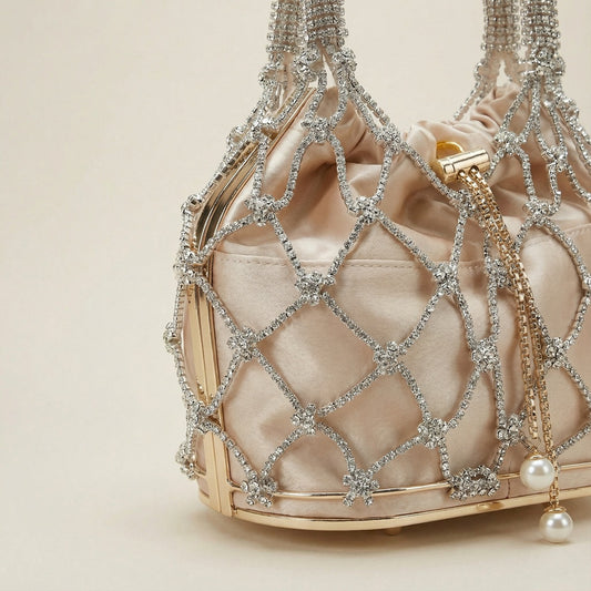 Close-up of Abby Bag showing champagne fabric, white rhinestone mesh, and pearl pendant detail