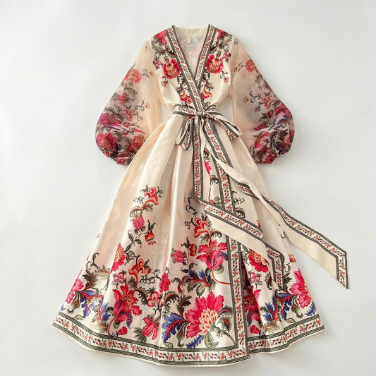 Garnet floral print maxi dress in deep wine red with sheer puff sleeves and wrap waist on a white display background.