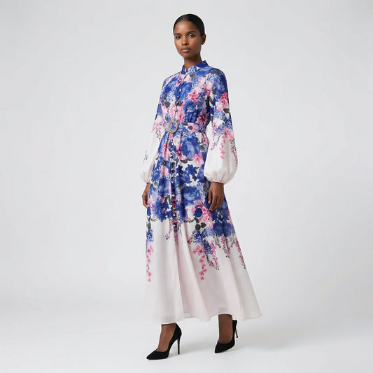 The Jana maxi dress in a 147 cm length featuring a long-sleeved ribbed knit bodice and a dramatic side-pleated accordion skirt with a matching waist belt.