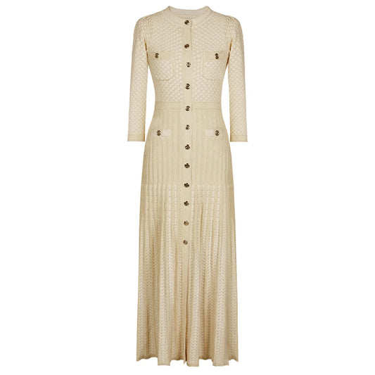 maxi dress with gold buttons and four front pockets displayed on a white background.