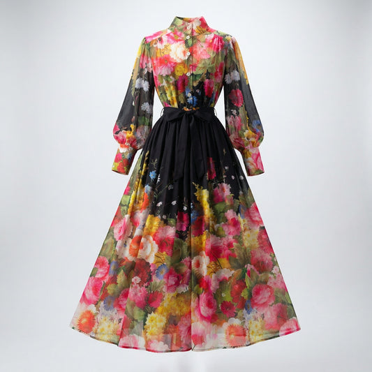 Lyana two-piece floral set featuring a long-sleeve chiffon button-down shirt and a matching 100cm maxi skirt in black and peach floral prints.