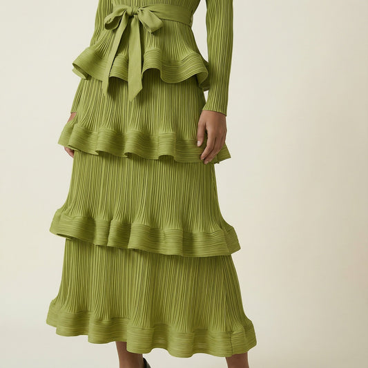 A woman modeling the Olivera long-sleeved blue ribbed knit dress.