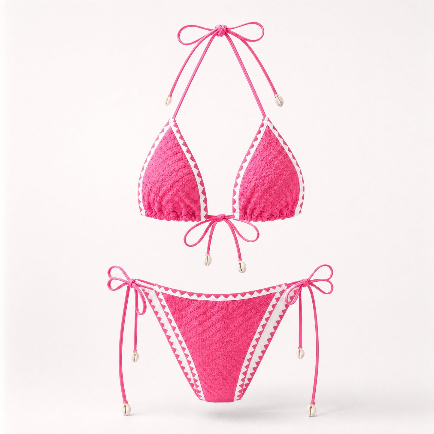 Bright pink popcorn fabric bikini set with cowrie shell accents.