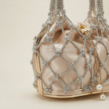 Close-up of Abby Bag showing champagne fabric, white rhinestone mesh, and pearl pendant detail