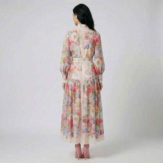 Full length view of the Abdulla floral maxi dress in pink and multicolor chiffon featuring lantern sleeves and a waist tie.