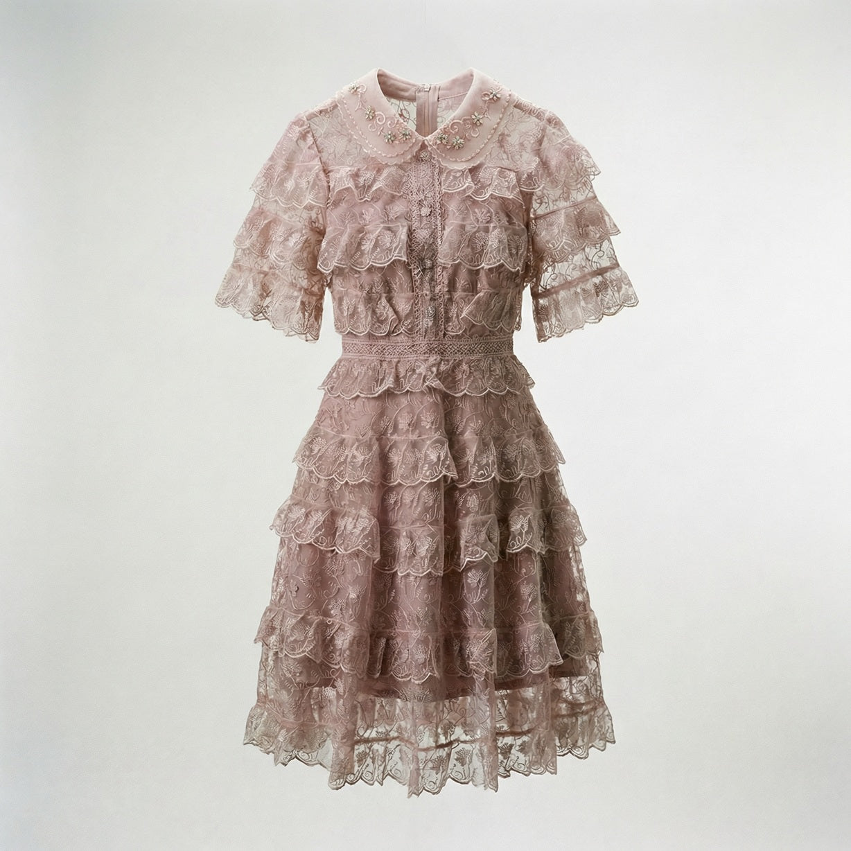 Adara tiered lace mini dress in dusty rose featuring floral lace and beaded collar.