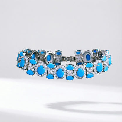 Adeline women's link bracelet featuring oval turquoise-colored stones surrounded by cubic zirconia halos on a silver-toned copper base.