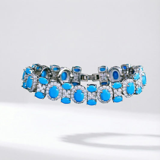 Adeline women's link bracelet featuring oval turquoise-colored stones surrounded by cubic zirconia halos on a silver-toned copper base.
