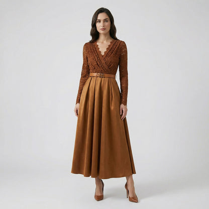 Adelmira midi-maxi dress in brown and black featuring a floral lace long-sleeve bodice, pleated skirt, and gold buckle belt.