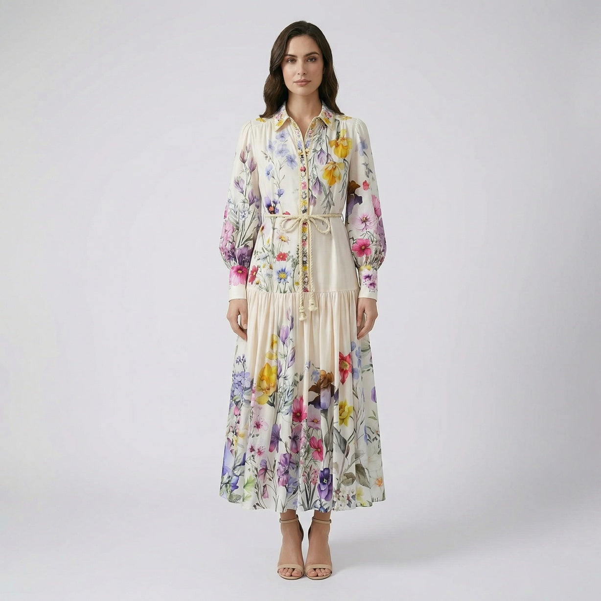 Full-length view of Adibah cream floral maxi dress with pink and purple flowers, bishop sleeves, and a braided rope belt