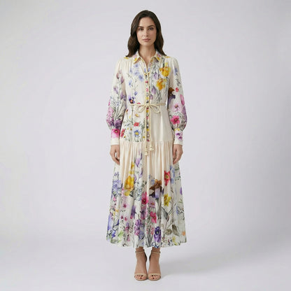 Full-length view of Adibah cream floral maxi dress with pink and purple flowers, bishop sleeves, and a braided rope belt