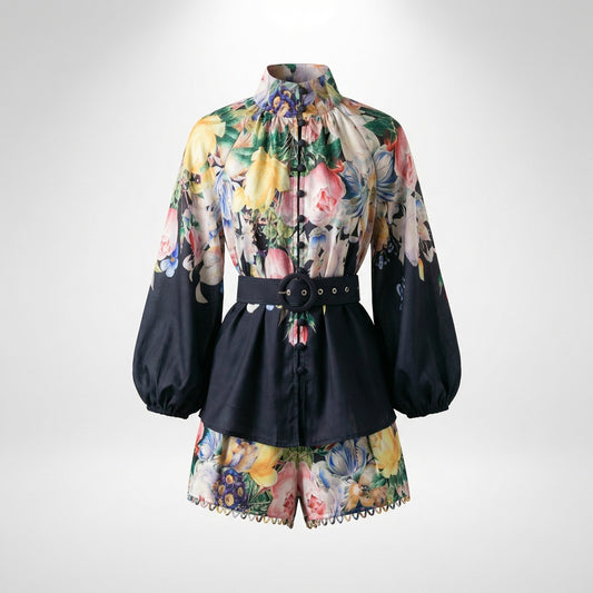 Alessandra two-piece set in black floral print featuring lantern sleeves and belted waist.