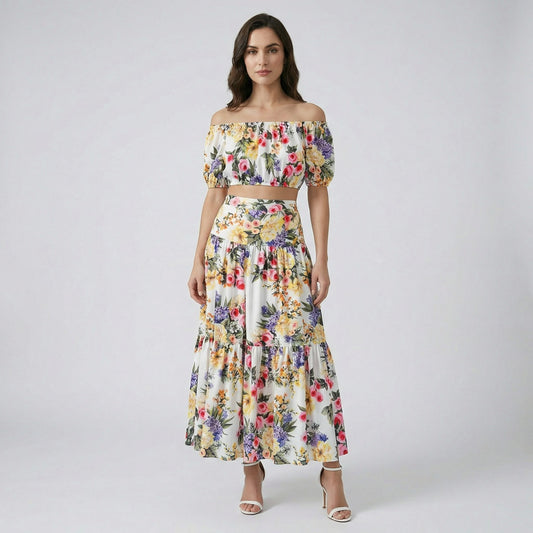 The Alexandra two-piece set featuring a white floral off-the-shoulder crop top and a matching 100cm tiered maxi skirt