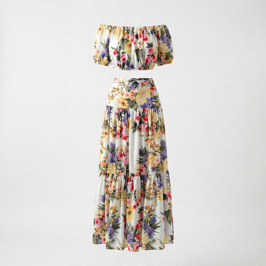 The Alexandra two-piece set featuring a white floral off-the-shoulder crop top and a matching 100cm tiered maxi skirt