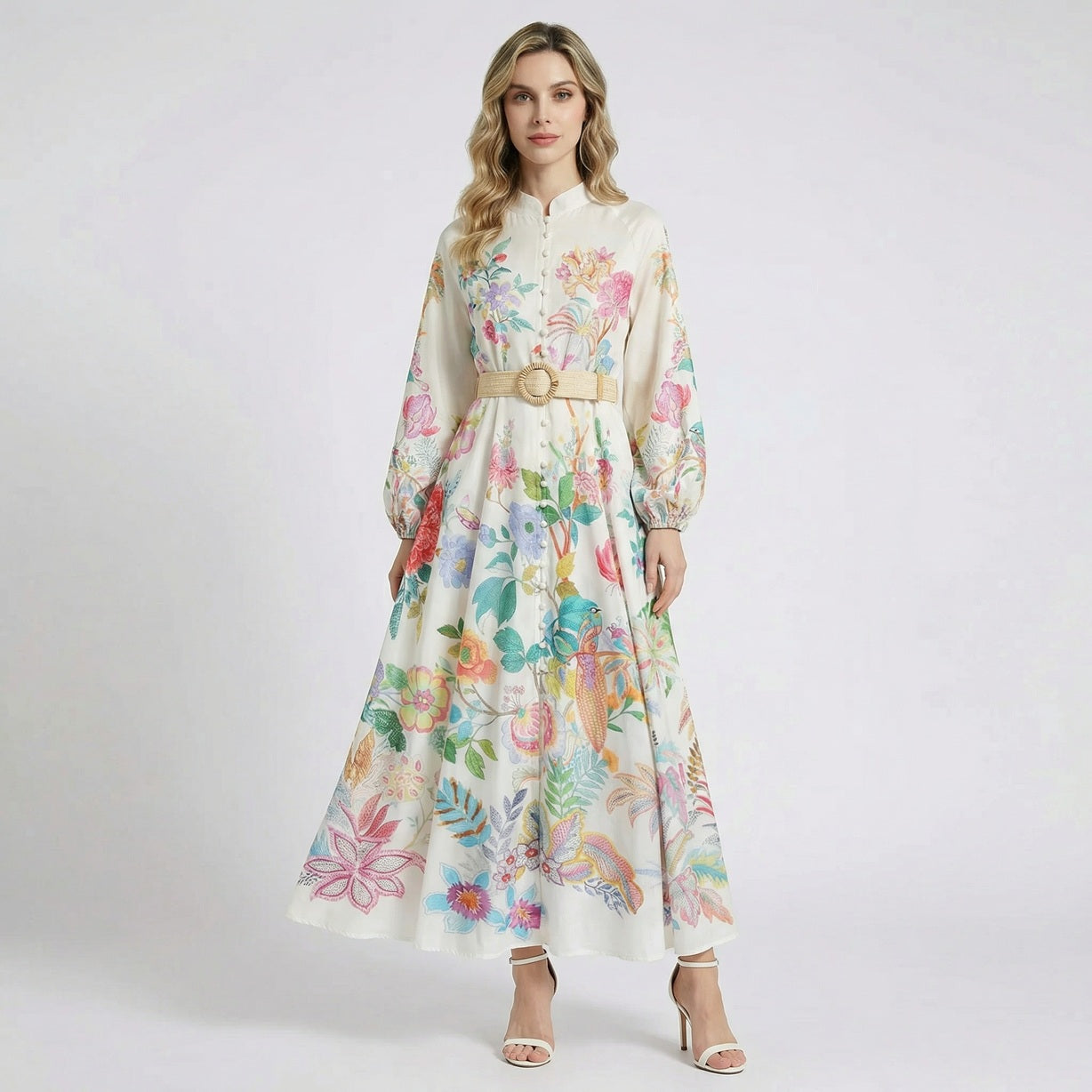 Arina white long-sleeve maxi dress with vibrant floral and bird prints, featuring a mandarin collar and a tan woven buckle belt.