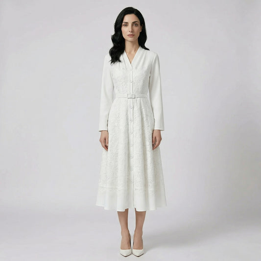 Front view of the Danka white midi-maxi dress featuring intricate floral lace, a button-down front, and a matching buckled belt.