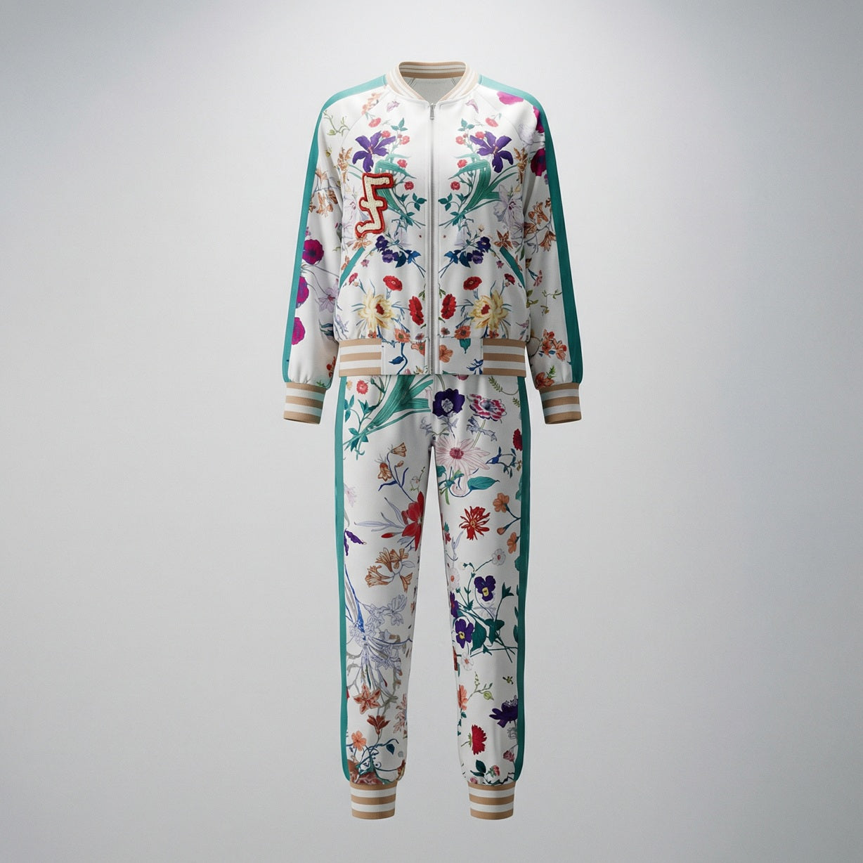 Woman wearing the Delia two-piece tracksuit featuring a floral print bomber jacket and matching joggers with teal side stripes.