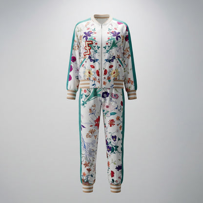Woman wearing the Delia two-piece tracksuit featuring a floral print bomber jacket and matching joggers with teal side stripes.
