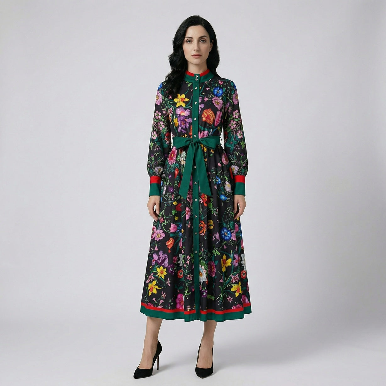 Full length view of the Eva floral maxi dress in white and black floral patterns featuring a green waist tie and 130cm length.