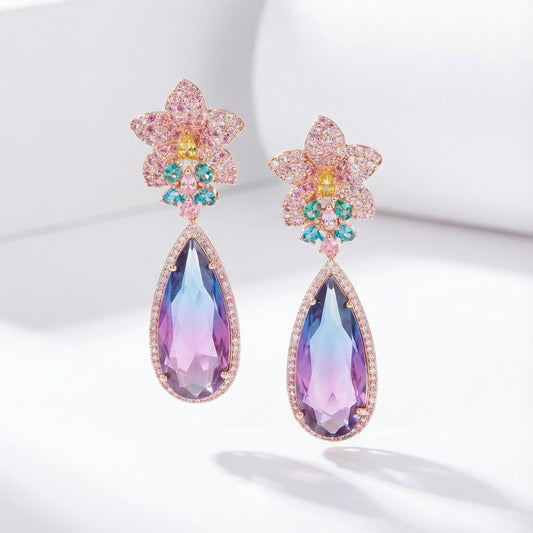 Gold floral drop earrings with multicolor details and oversized purple stone