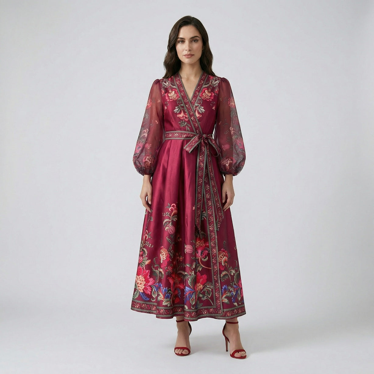 Garnet floral print maxi dress in deep wine red with sheer puff sleeves and wrap waist on a white display background.