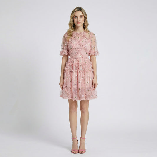 Front view of Graciane pink mini dress with floral embroidery and tiered ruffles