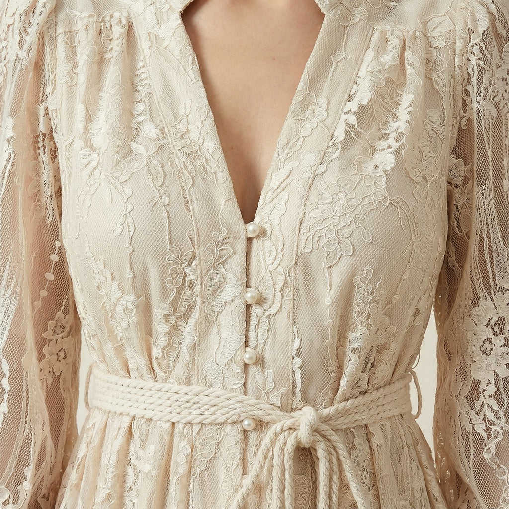 Hamida v-neck dress in white close up featuring romantic lace long sleeves and faux pearl buttons.