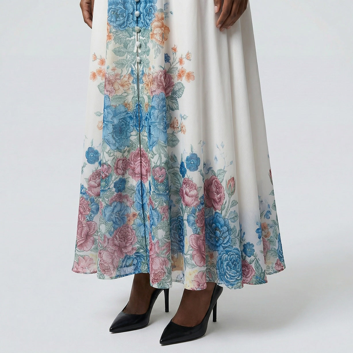 The Heba maxi dress in a 141 cm length featuring a long-sleeved ribbed knit bodice and a dramatic side-pleated accordion skirt with a matching waist belt.