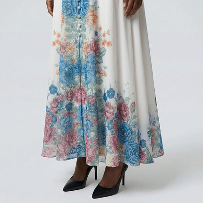 The Heba maxi dress in a 141 cm length featuring a long-sleeved ribbed knit bodice and a dramatic side-pleated accordion skirt with a matching waist belt.