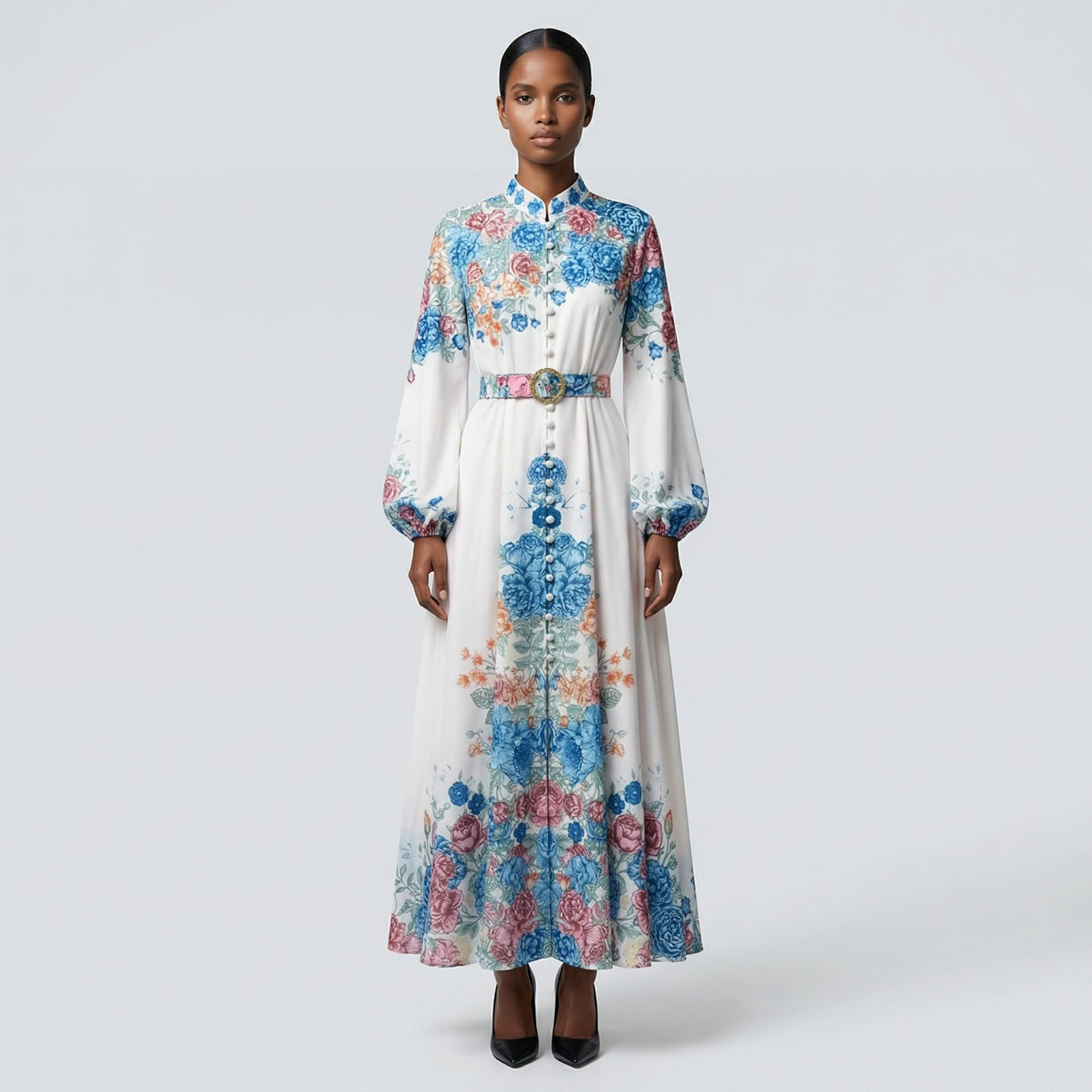 The Heba maxi dress in a 141 cm length featuring a long-sleeved ribbed knit bodice and a dramatic side-pleated accordion skirt with a matching waist belt.