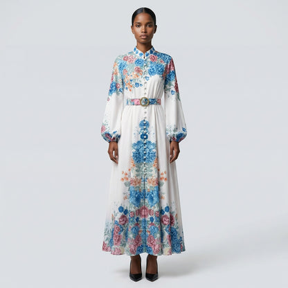 The Heba maxi dress in a 141 cm length featuring a long-sleeved ribbed knit bodice and a dramatic side-pleated accordion skirt with a matching waist belt.