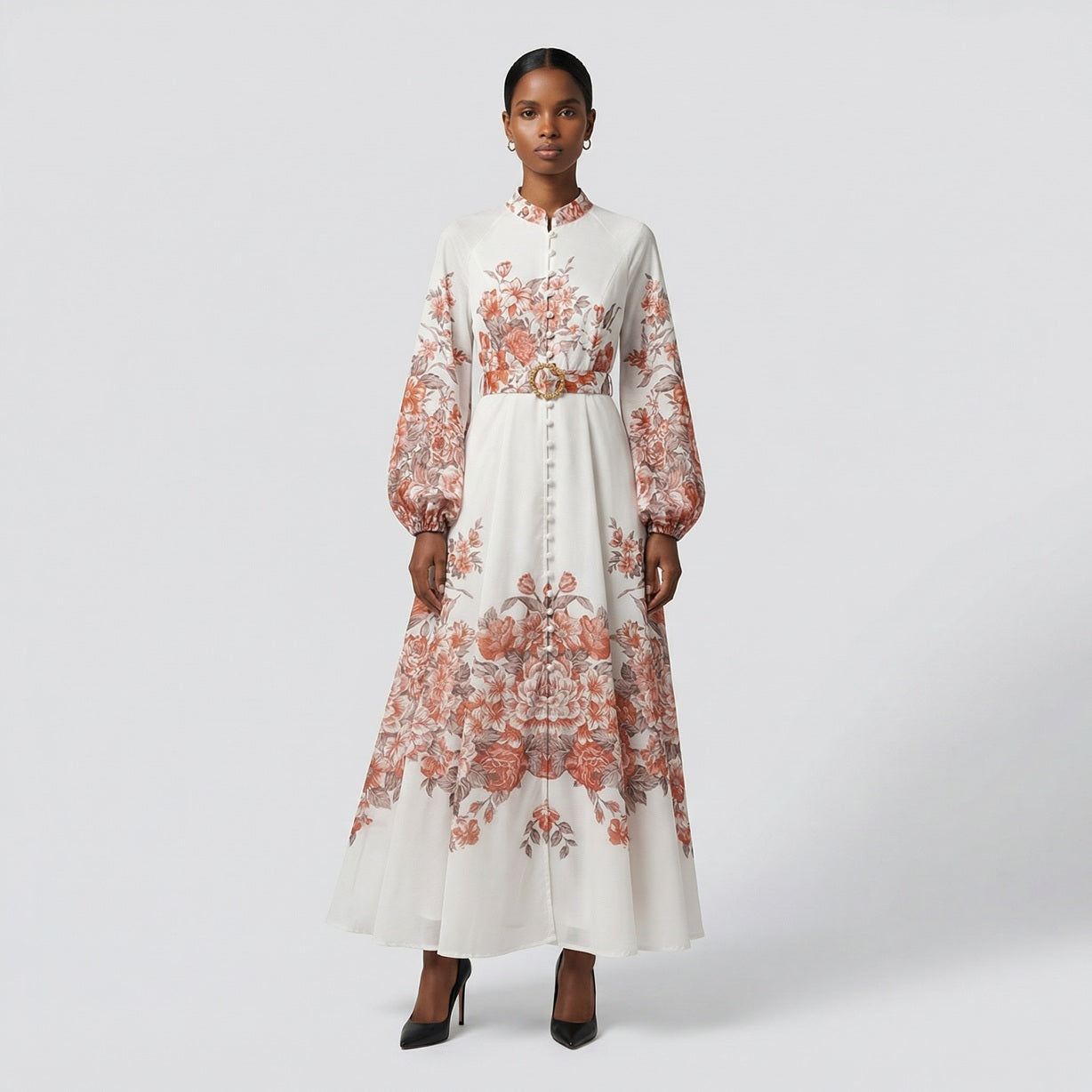 The Heba maxi dress in a 141 cm length featuring a long-sleeved ribbed knit bodice and a dramatic side-pleated accordion skirt with a matching waist belt.