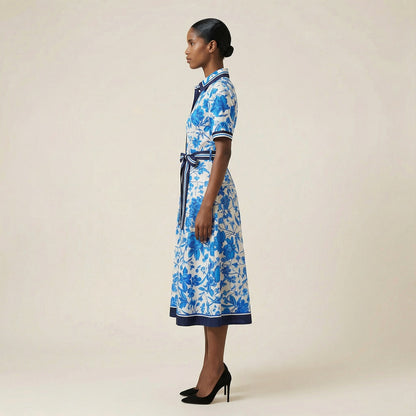 he Inese midi dress in a vibrant blue and red colorway, featuring a long-sleeved ribbed knit bodice and a side-pleated accordion skirt with a matching waist belt.