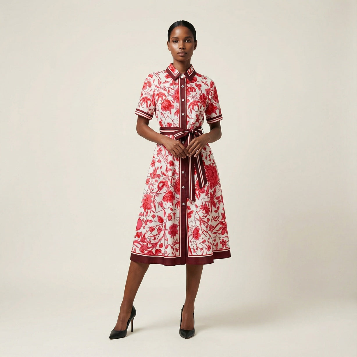 he Inese midi dress in a vibrant blue and red colorway, featuring a long-sleeved ribbed knit bodice and a side-pleated accordion skirt with a matching waist belt.