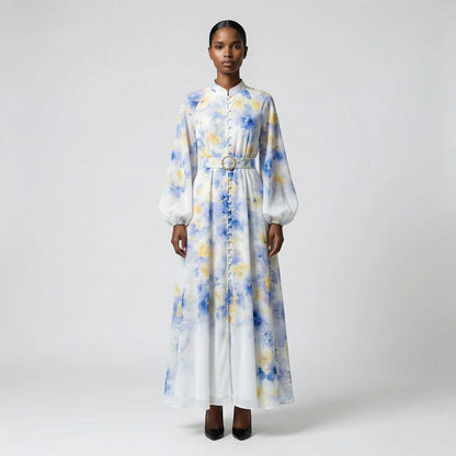 The Jana maxi dress in a 147 cm length featuring a long-sleeved ribbed knit bodice and a dramatic side-pleated accordion skirt with a matching waist belt.