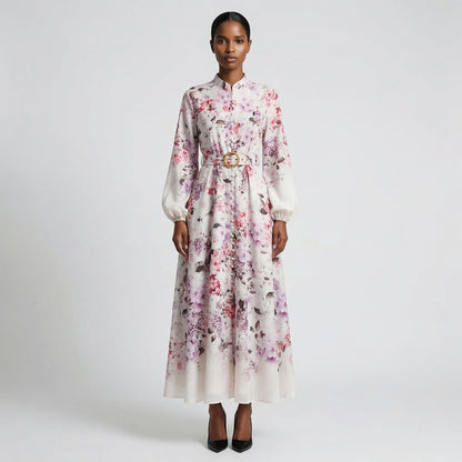 The Jana maxi dress in a 147 cm length featuring a long-sleeved ribbed knit bodice and a dramatic side-pleated accordion skirt with a matching waist belt.