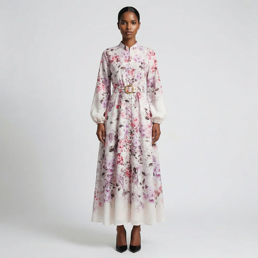 The Jana maxi dress in a 147 cm length featuring a long-sleeved ribbed knit bodice and a dramatic side-pleated accordion skirt with a matching waist belt.