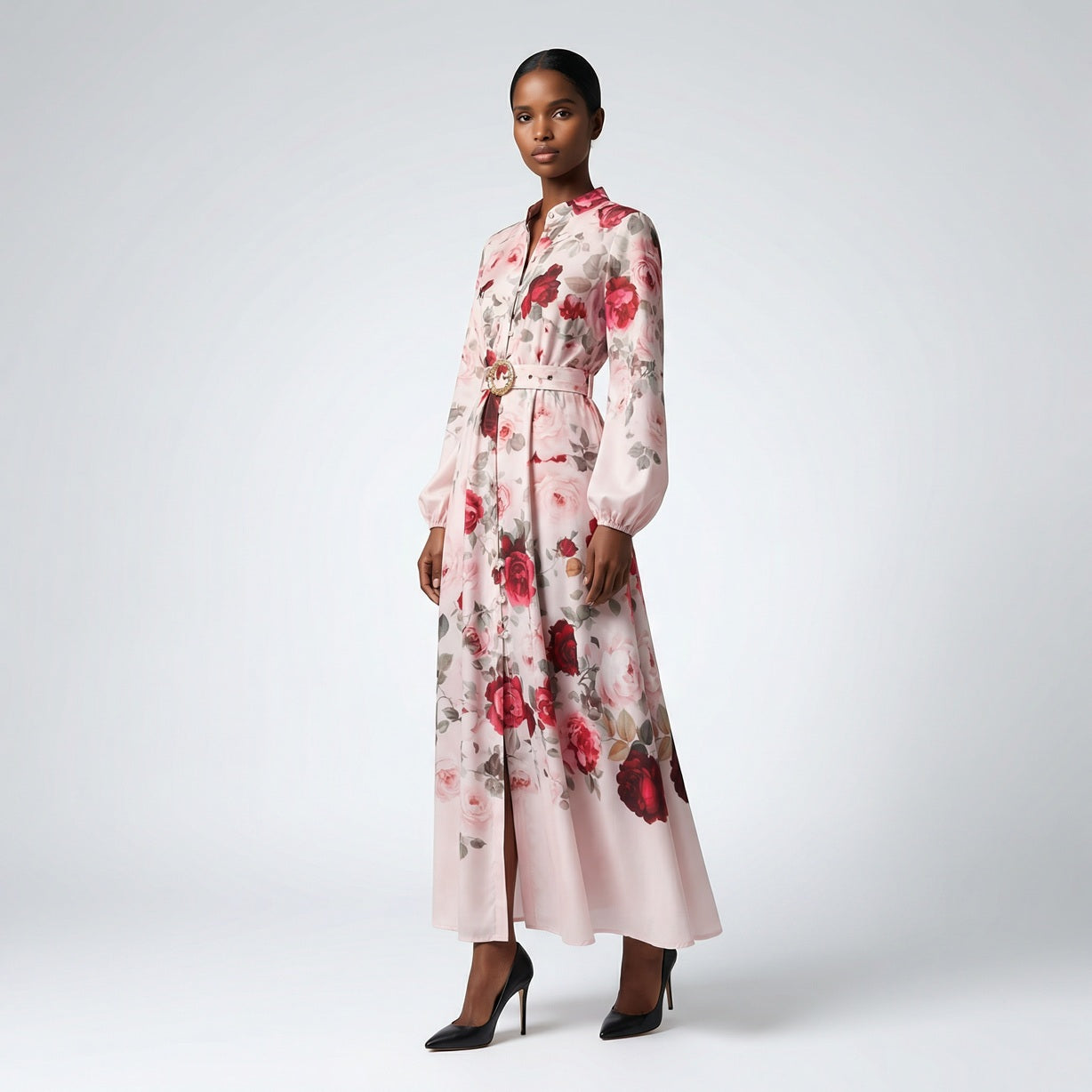 The Jana maxi dress in a 147 cm length featuring a long-sleeved ribbed knit bodice and a dramatic side-pleated accordion skirt with a matching waist belt.