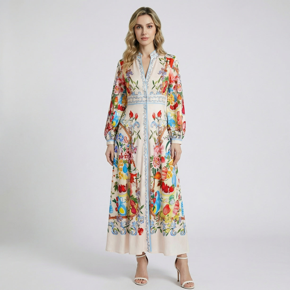 Long-sleeved Jolinah maxi dress with colorful Mediterranean floral and fruit print on cream background, 135cm length.