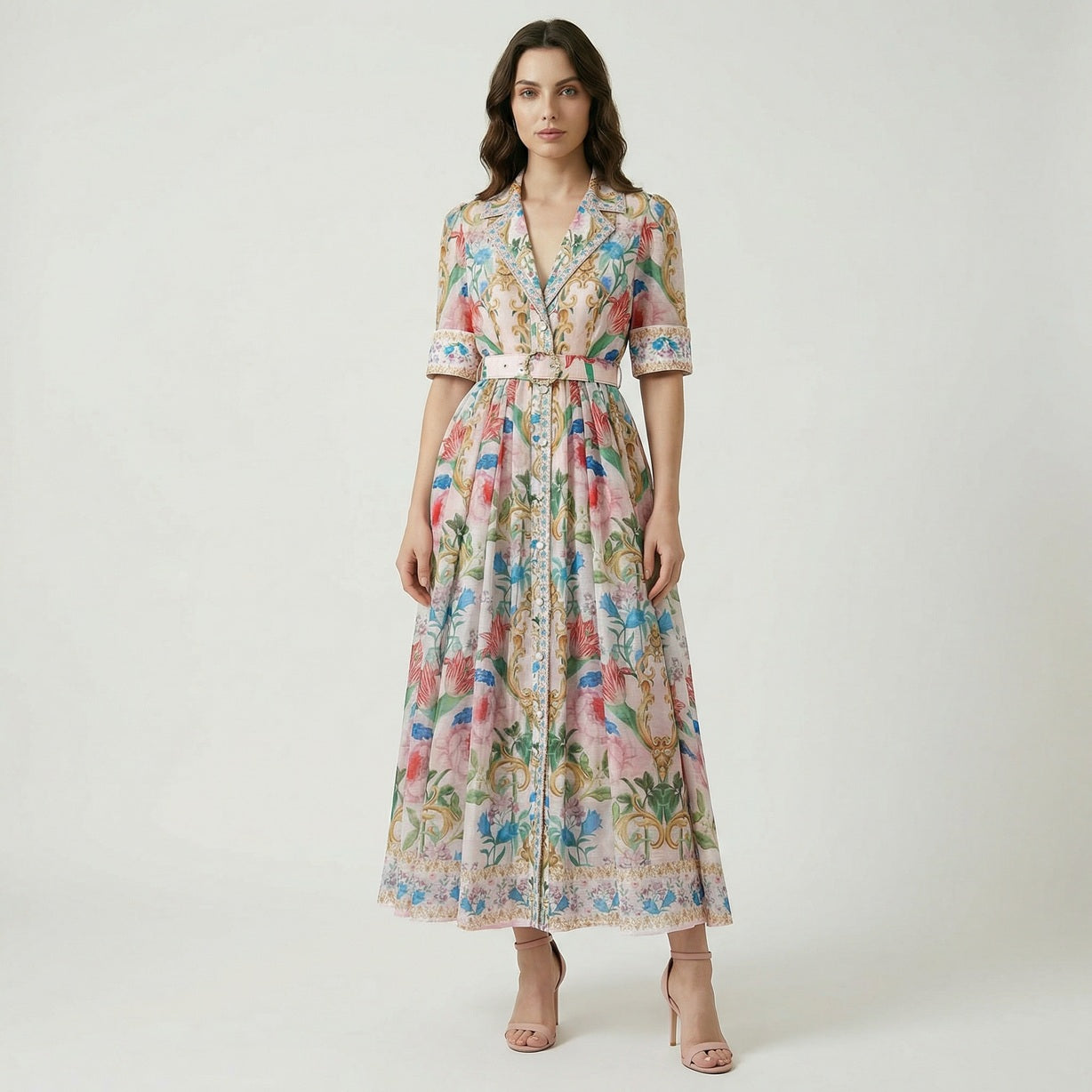 The Judith Maxi Dress in cream and navy featuring a floral baroque print, notched collar, button-down front, and a matching gold buckle belt on a flat lay display.