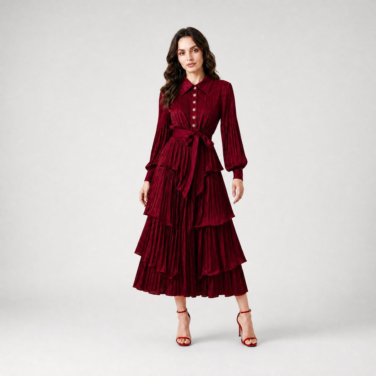 Julia Dress in burgundy, a long-sleeved pleated maxi dress with tiered ruffles and a waist tie.