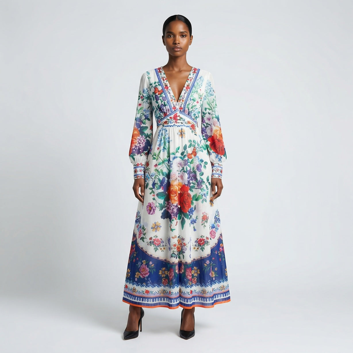 Front view of the Julie maxi dress in white featuring colorful floral and butterfly prints with a button-down front and V-neckline.