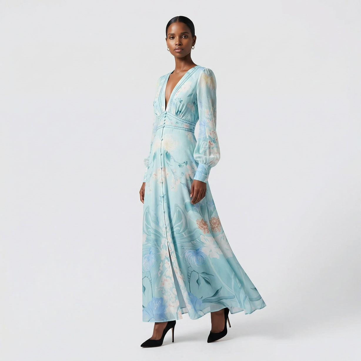 Front view of the Julie maxi dress in white featuring colorful floral and butterfly prints with a button-down front and V-neckline.