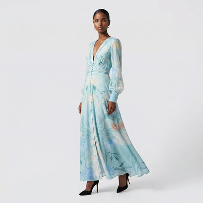 Front view of the Julie maxi dress in white featuring colorful floral and butterfly prints with a button-down front and V-neckline.