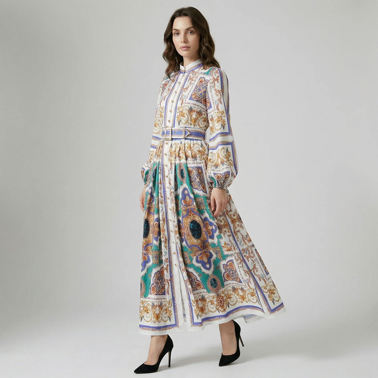 Full length view of Kristin maxi dress featuring white, blue, and gold baroque print with lantern sleeves and a cinched belted waist.