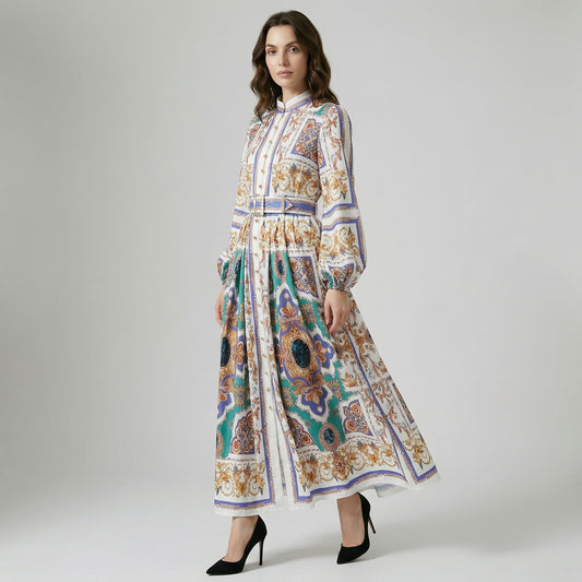 Full length view of Kristin maxi dress featuring white, blue, and gold baroque print with lantern sleeves and a cinched belted waist.