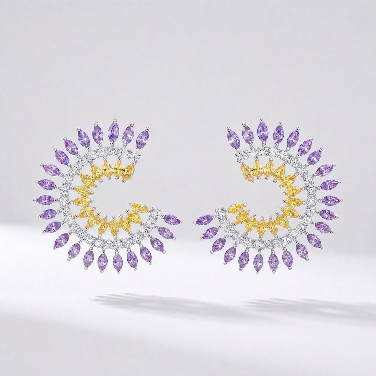 Pair of Leah spiral earrings in blue/green and purple/yellow color options featuring marquise cubic zirconia stones.
Leah earrings, spiral stud earrings, colorful cz earrings, marquise cut jewelry, statement studs, versatile formal earrings, cubic zirconia jewelry