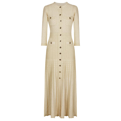 maxi dress with gold buttons and four front pockets displayed on a white background.