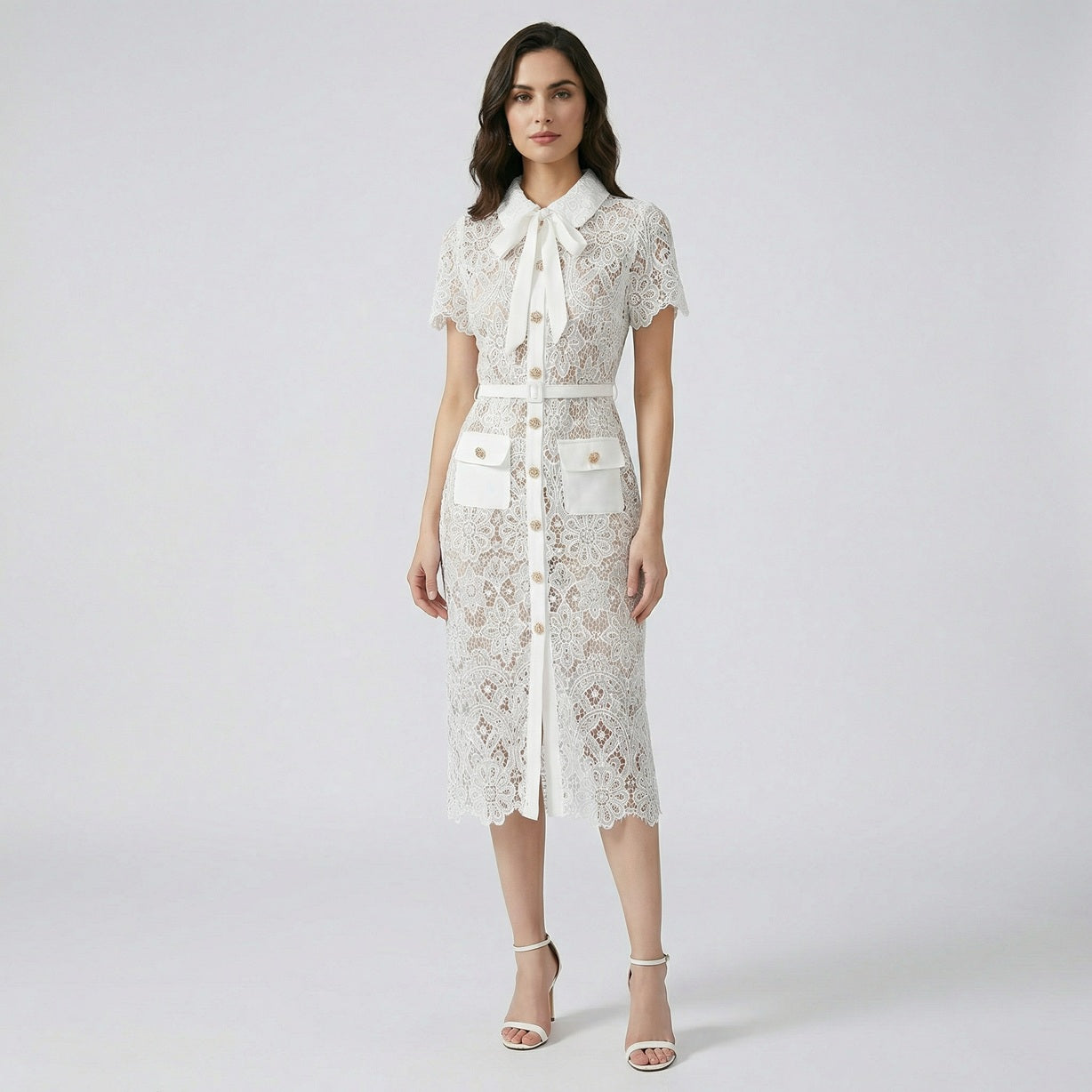 Front view of Lya white floral guipure lace midi shirt dress with gold buttons and bow collar.