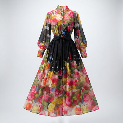 Lyana two-piece floral set featuring a long-sleeve chiffon button-down shirt and a matching 100cm maxi skirt in black and peach floral prints.